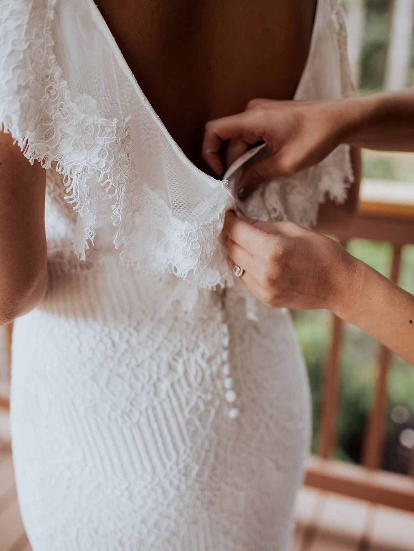 Detail of lace gown back being fastened